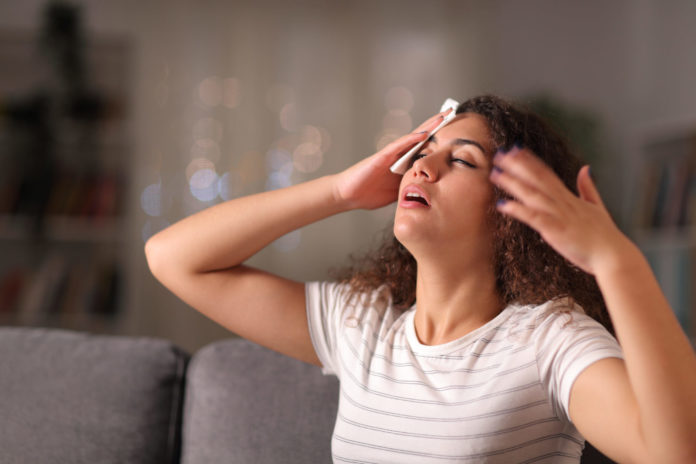 Stressed,Woman,Drying,Sweat,In,A,Warm,Night,Sitting,On